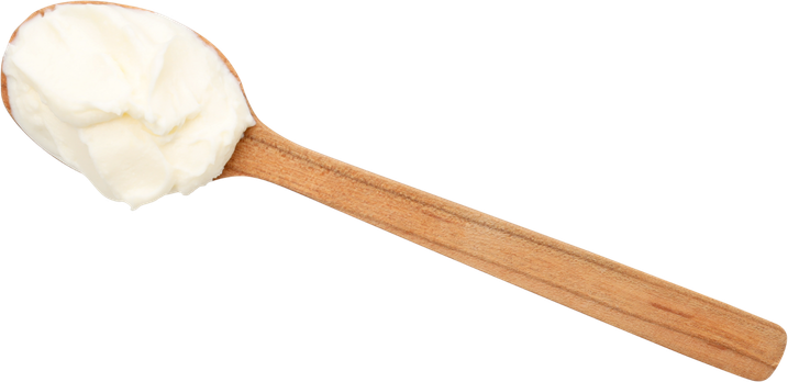 A wooden spoon filled with curd